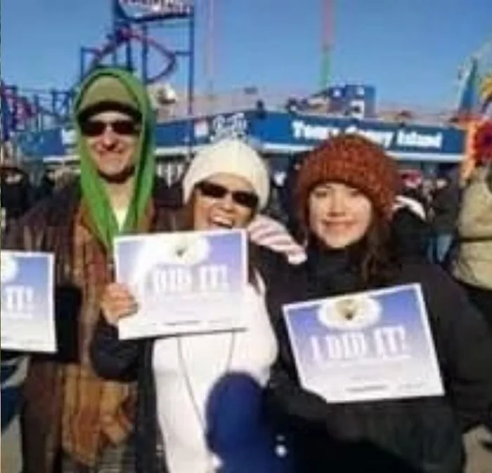 Isa Herrera and family at the Coney Island Polar Bear Plunge holding signs reading I DID IT.