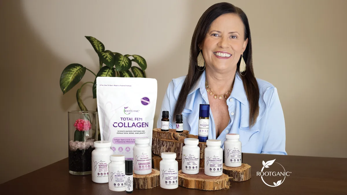 Isa Herrera at a wood table with a Total Fem Collagen pouch and white supplement bottles.